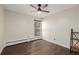 Bedroom with large window, wood flooring and a built-in shelving unit at 310 S Ames St # 11, Lakewood, CO 80226