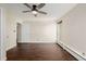 Bright bedroom with large window and dark brown wood flooring at 310 S Ames St # 11, Lakewood, CO 80226