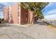 Side view of the brick apartment building with parking at 310 S Ames St # 11, Lakewood, CO 80226