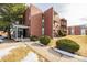 Brick apartment building with landscaping and parking area at 310 S Ames St # 11, Lakewood, CO 80226