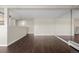 Living room with dark laminate floors and mirrored accent wall at 310 S Ames St # 11, Lakewood, CO 80226