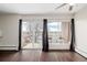 Living room with balcony access and treetop views at 310 S Ames St # 11, Lakewood, CO 80226