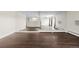 Spacious living room featuring dark laminate floors and mirrored wall at 310 S Ames St # 11, Lakewood, CO 80226