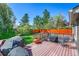 Spacious wood deck with outdoor seating, grilling area, and view of the lush, fenced backyard at 6527 S Yarrow Way, Littleton, CO 80123