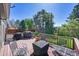 Inviting wood deck featuring a grill, comfortable seating, and a view of the landscaped backyard at 6527 S Yarrow Way, Littleton, CO 80123