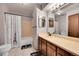 Functional bathroom featuring a vanity and shower-tub combination at 6527 S Yarrow Way, Littleton, CO 80123