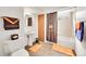Cozy bathroom with pedestal sink, orange accent rugs, and a shower-tub combination with a Broncos shower curtain at 6527 S Yarrow Way, Littleton, CO 80123