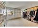 Walk-in closet with custom storage solutions, shoe racks, and ample hanging space at 6527 S Yarrow Way, Littleton, CO 80123