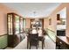 Elegant dining room featuring a large table, a china cabinet, and bright natural light at 6527 S Yarrow Way, Littleton, CO 80123