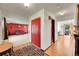 Inviting foyer featuring hardwood floors, red accent doors, and a view into the spacious living area at 6527 S Yarrow Way, Littleton, CO 80123