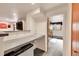 Basement bar area featuring a modern countertop and a mini fridge at 6527 S Yarrow Way, Littleton, CO 80123