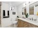 Modern bathroom featuring double vanity with marble countertop and decorative tile in shower at 201 Greenwood Blvd, Denver, CO 80221