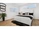 Bright bedroom with a minimalist design featuring a large bed and modern artwork on white walls at 201 Greenwood Blvd, Denver, CO 80221