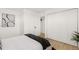 Modern bedroom featuring new laminate floors, closet space, and modern minimalist decorations at 201 Greenwood Blvd, Denver, CO 80221