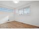 Bedroom with lots of natural light featuring laminate floors, fresh paint, and modern blinds at 201 Greenwood Blvd, Denver, CO 80221