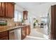 Updated kitchen with granite counters, stainless steel appliances, and a view of the dining room at 201 Greenwood Blvd, Denver, CO 80221