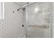 This walk in shower features white subway tiles and glass doors at 201 Greenwood Blvd, Denver, CO 80221