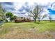 Large backyard with beautiful landscaping and a spacious deck at 73 N Dutch Valley Rd, Bennett, CO 80102