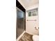 Bathroom featuring a glass shower with dark accent tiles and a narrow window at 73 N Dutch Valley Rd, Bennett, CO 80102