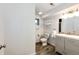 Bright bathroom featuring a modern vanity, wood-look floors, and crisp, white walls at 73 N Dutch Valley Rd, Bennett, CO 80102