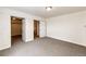 Bedroom with carpet floors, closet and bathroom doorway entrances at 73 N Dutch Valley Rd, Bennett, CO 80102