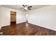Bedroom with hardwood flooring, ceiling fan, closet, and view into bathroom at 73 N Dutch Valley Rd, Bennett, CO 80102