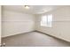 Bedroom with carpet floor, baseboard trim and a large window at 73 N Dutch Valley Rd, Bennett, CO 80102