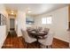 Dining room with wood floors, six-chair table and decorative chandelier at 73 N Dutch Valley Rd, Bennett, CO 80102