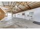 The large garage has an open layout, large metal roof, and multiple bays with rolling doors at 73 N Dutch Valley Rd, Bennett, CO 80102