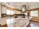 The kitchen has stainless appliances, granite counters, hardwood floors and ample lighting at 73 N Dutch Valley Rd, Bennett, CO 80102