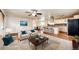 A virtually staged living room has hardwood floors, a rug, and contemporary furniture at 73 N Dutch Valley Rd, Bennett, CO 80102