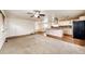 Open living space has hardwood floors, a kitchen island and carpeted living room at 73 N Dutch Valley Rd, Bennett, CO 80102