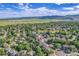 An aerial view capturing the home, its neighborhood, and the surrounding landscape with distant mountains at 2742 S Braun Way, Lakewood, CO 80228