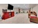 Finished basement offers a cozy seating area and a red entertainment center at 2742 S Braun Way, Lakewood, CO 80228