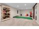 Basement rec room with a mini putting green, slide, and basketball hoop provides entertainment at 2742 S Braun Way, Lakewood, CO 80228
