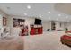 Spacious finished basement featuring a large TV, play area, and comfortable seating at 2742 S Braun Way, Lakewood, CO 80228