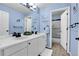 Bathroom featuring dual vanities, framed mirrors, and a separate toilet and shower area at 2742 S Braun Way, Lakewood, CO 80228