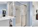 Bathroom showcasing a tiled walk-in shower with glass doors and a vanity with sink at 2742 S Braun Way, Lakewood, CO 80228