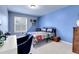 A bedroom with Marvel themed decor, a desk, and a window allowing natural light at 2742 S Braun Way, Lakewood, CO 80228
