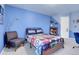 A bedroom featuring Marvel themed decor, a reading chair, and bookshelves at 2742 S Braun Way, Lakewood, CO 80228