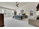 Main bedroom with vaulted ceiling, a seating area, and large windows with shutter-style blinds at 2742 S Braun Way, Lakewood, CO 80228