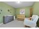 Bright Bedroom with a wooden crib, gray dresser, and a comfortable white rocking chair at 2742 S Braun Way, Lakewood, CO 80228