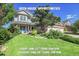 Charming two-story home with a manicured lawn and mature trees, offering an inviting curb appeal for potential buyers at 2742 S Braun Way, Lakewood, CO 80228