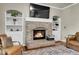 Close up of brick fireplace with built-in shelving in living room with hardwood floors and area rug at 2742 S Braun Way, Lakewood, CO 80228