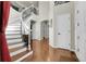 Grand foyer with curved staircase, hardwood floors, and high ceilings creating an open and inviting entrance at 2742 S Braun Way, Lakewood, CO 80228