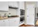 Bright kitchen featuring stainless steel appliances, granite countertops, and hardwood floors at 2742 S Braun Way, Lakewood, CO 80228