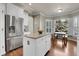 Bright kitchen featuring an island with granite countertops and stainless steel appliances at 2742 S Braun Way, Lakewood, CO 80228
