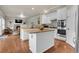 Modern kitchen featuring an island, granite countertops, stainless steel appliances, and hardwood floors at 2742 S Braun Way, Lakewood, CO 80228