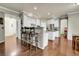 Bright kitchen featuring white cabinets, stainless steel appliances, hardwood floors and bar stool seating at 2742 S Braun Way, Lakewood, CO 80228
