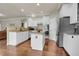 Bright kitchen featuring an island, granite countertops, stainless steel appliances, and hardwood floors at 2742 S Braun Way, Lakewood, CO 80228